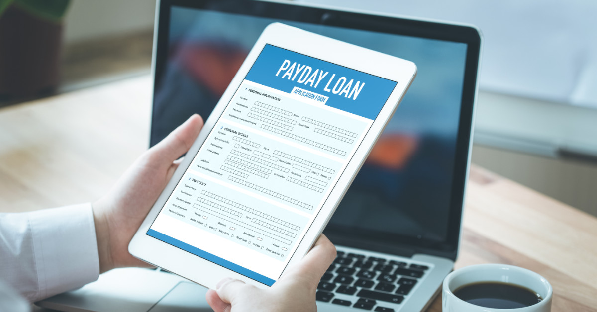 Payday Loan graphic on iPad being held by person needing a loan